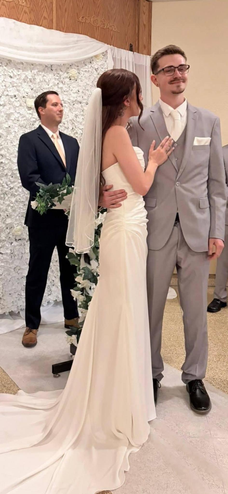 A Lakeland Cabaret officiant standing with a newly married couple